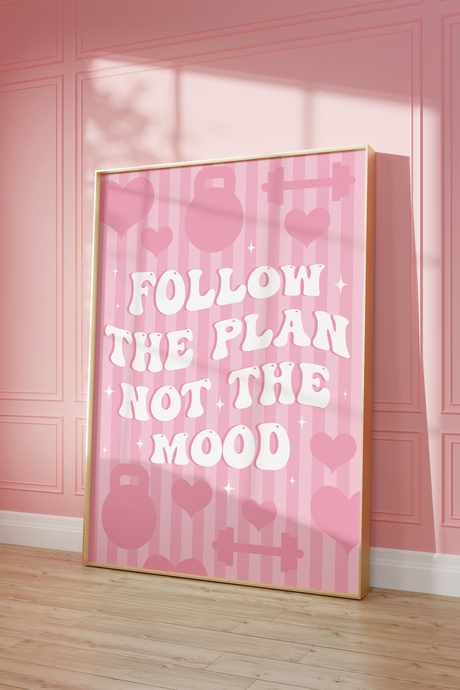 Pink gym wall art print featuring the motivational quote "Follow The Plan Not The Mood" in bold white lettering.