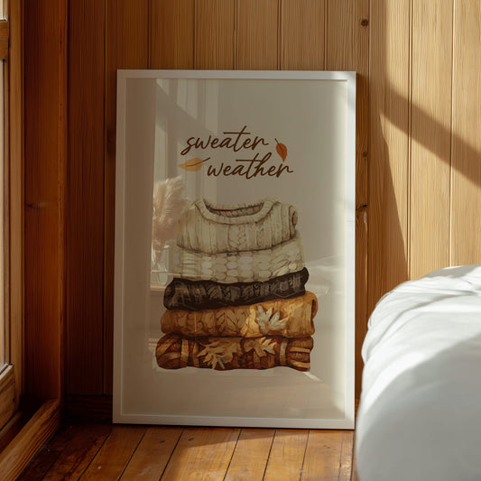 Sweater Weather wall art print with cozy stack of autumn sweaters.